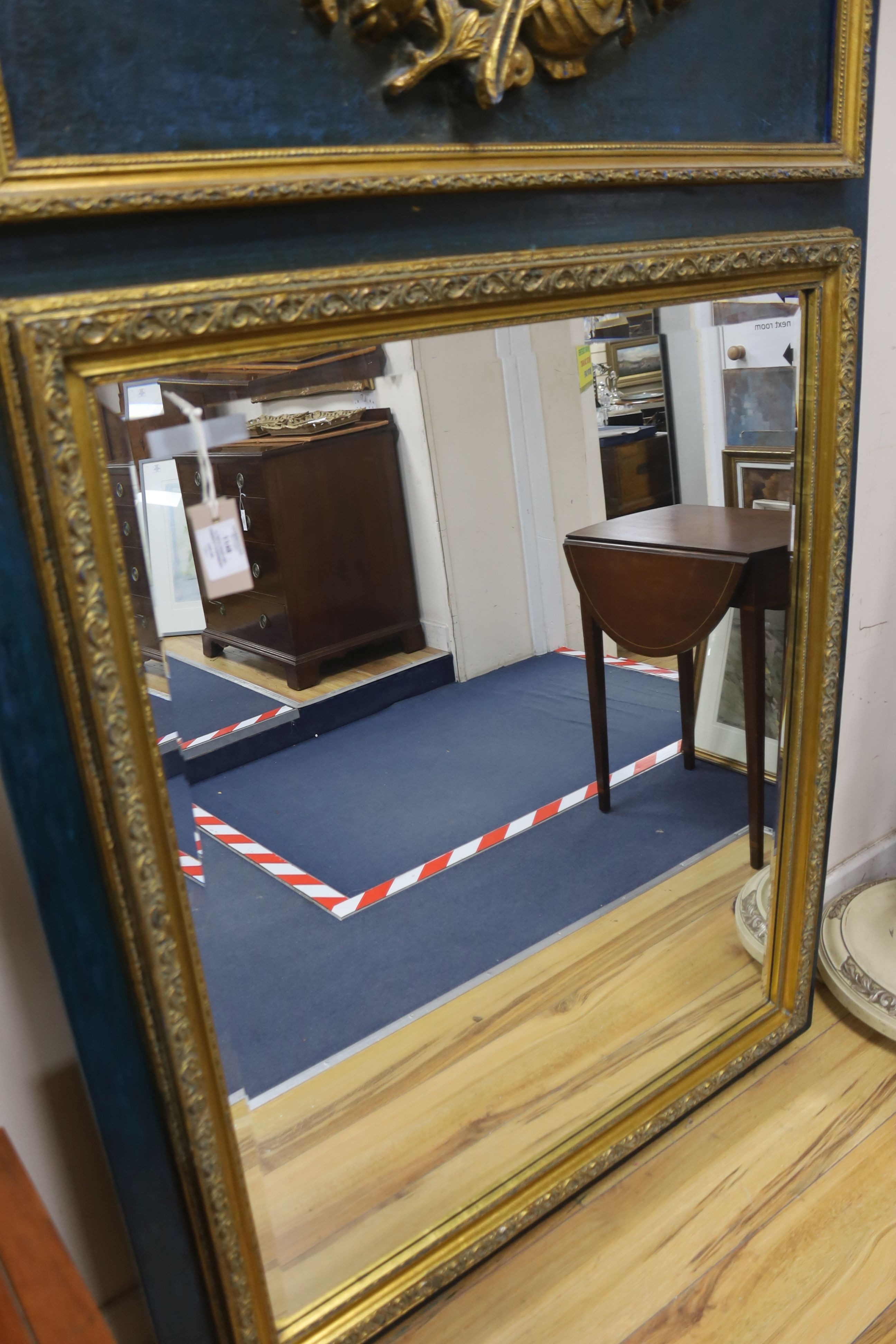 A 19th century French overmantel gilt and gesso mirror with musical themed emblem over on blue background, width 114cm, height 172cm